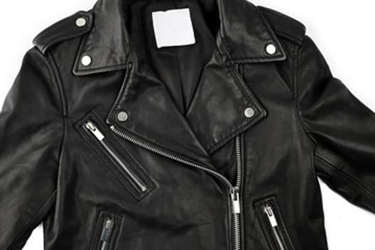 A black leather biker jacket with silver zippers and snap buttons, laid flat on a white background.